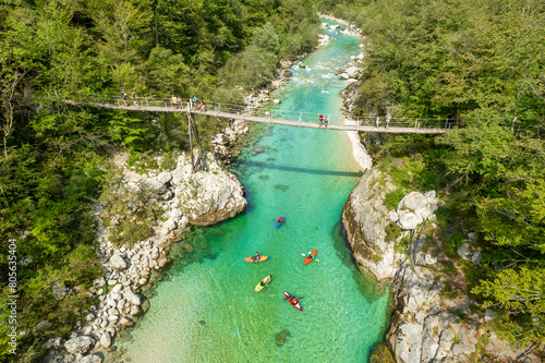 Obraz na płótnie A suspension bridge spans the emerald waters of the Soca River in Slovenia w salonie