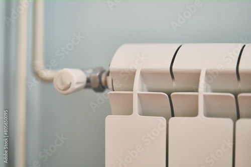White heating metal radiator with a pipe close up. High quality photo