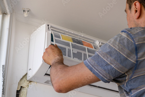 technician service removing air filter of air conditioner Lviv Ukraine 08.04.24