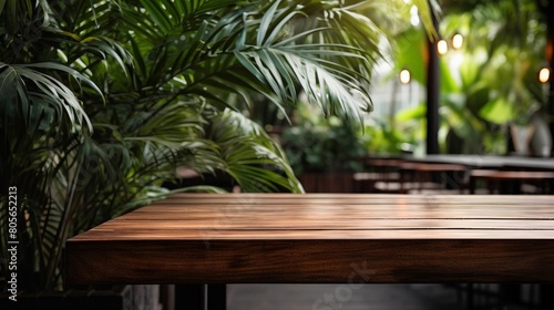 A wooden table with a plant in front of it