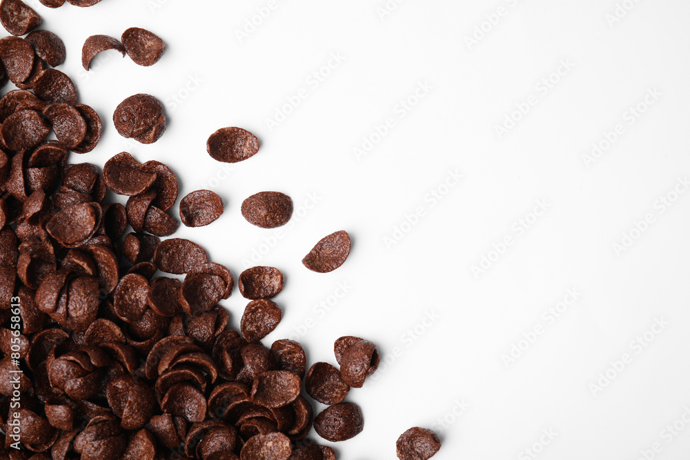 Breakfast cereal. Chocolate corn flakes on white background, flat lay. Space for text Breakfast cereal. Chocolate corn flakes on white background, flat lay. Space for text