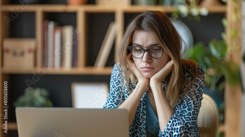 An online workshop in progress with one attendee visibly bored, looking away from the screen and checking the time