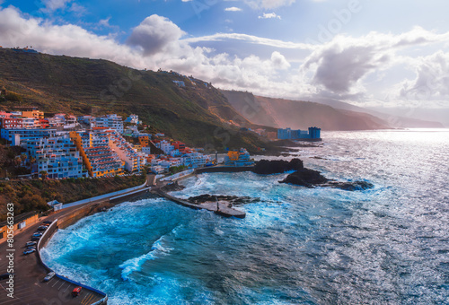 Drone aerial view of the coastline El Pris - Little Jetty illuminated at sunset in the Canary Islands in Spain - Europe © cristianbalate