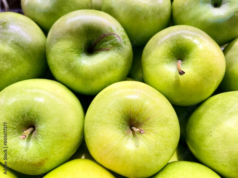 close-up of green apples stacked on the display of an organic producer
close-up of green apples stacked on the display of an organic producer