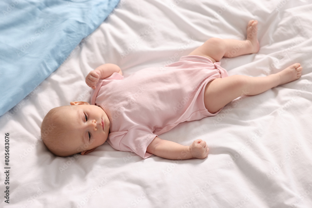 Cute little baby lying on white sheets Cute little baby lying on white sheets