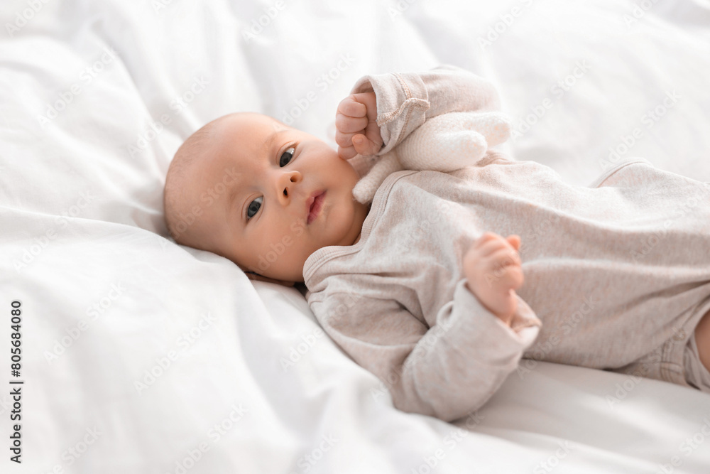 Cute little baby lying on white sheets Cute little baby lying on white sheets