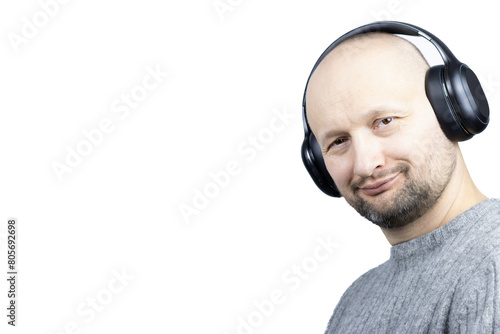 This is a captivating portrait of a man, set against a stark white background. He is clad in a finely knit grey wool sweater, his face expressing joy and contentment photo