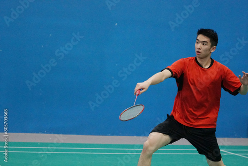 A very focused young player who plays single badminton.