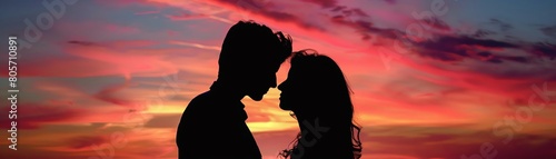 Silhouette of a young couple at sunset, capturing a tender moment, vibrant and emotive
