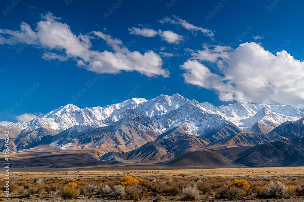 majestic snowcapped mountain range beneath vibrant blue skies panoramic landscape photography