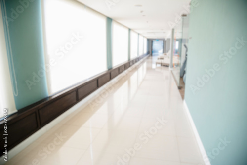 Blurred background hospital healthcare white bokeh with copy space. Blue clean bright blurry background medical laboratory backdrop. Interior lobby simple living space light bokeh. Blurry hallway © aFotostock