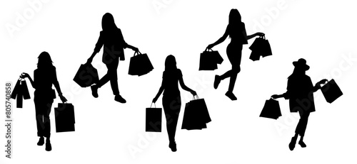 Silhouette of  slim young woman carrying shopping bags.