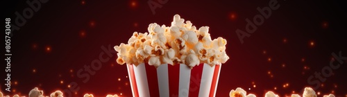 delicious popcorn in a striped box against a dark background