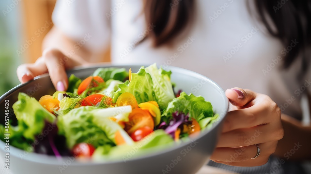 With grace and elegance, these hands present a plate of herb salad, a reflection of the love and care we show to our bodies With grace and elegance, these hands present a plate of herb salad, a reflection of the love and care we show to our bodies