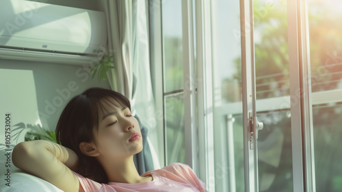 Photo of a young Asian woman Sleep and relax with air conditioning in a relaxing, cool room. Free Download Photo of a young Asian woman Sleep and relax with air conditioning in a relaxing, cool room. - GFXLoad