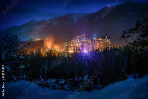 Beautiful mountain view with Fairmont Banff Springs Hotel, located in Banff National Park, Alberta in Canada during winter time at night. It is called "Castle in the Rockies".