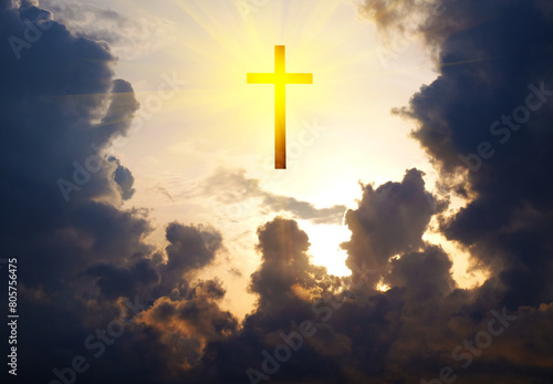 Cross of Jesus Christ in the sky with clouds and sun rays.
