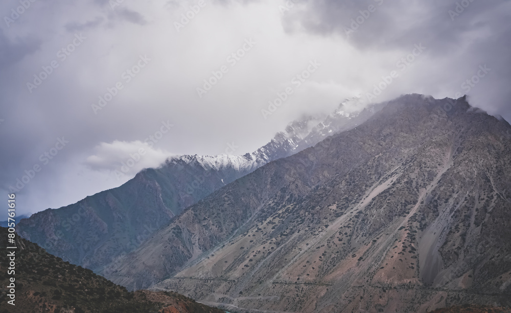 Mountain range with freshly fallen snow in cloudy weather in the mountains