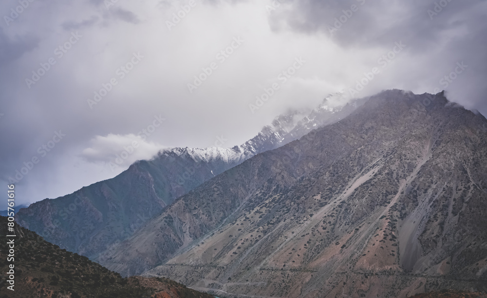 Fototapeta premium Mountain range with freshly fallen snow in cloudy weather in the mountains