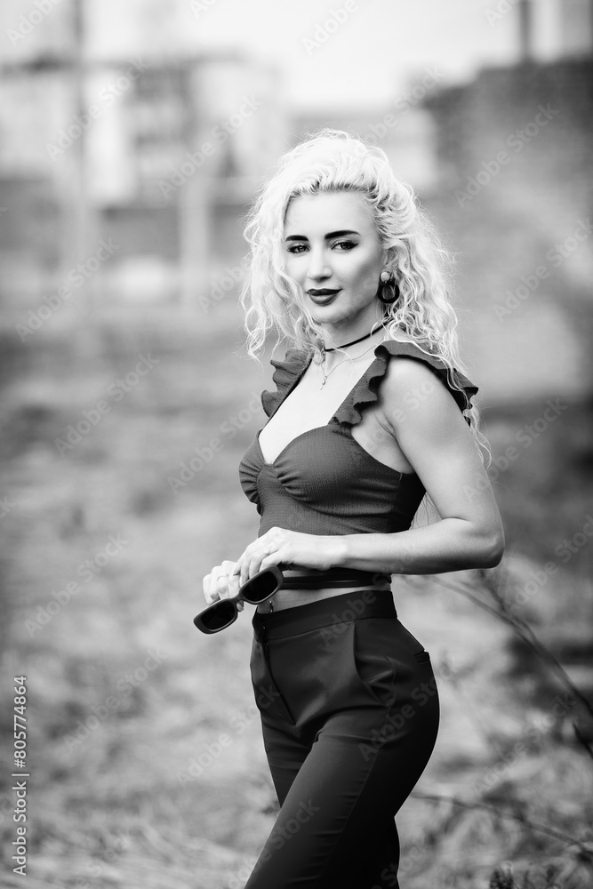 Portrait of a young beautiful blonde girl outdoors. Black and white photo. Portrait of a young beautiful blonde girl outdoors. Black and white photo.