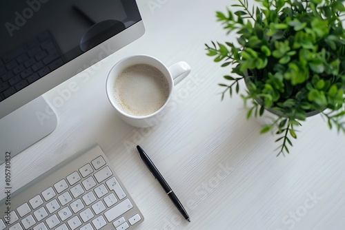 White office desk with coffee mug and computer for work, space to add more writing.