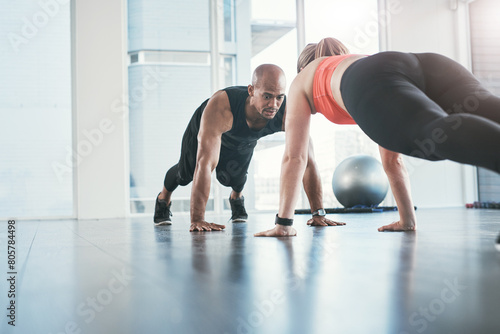 Fitness, instructor and pushups exercise in gym, diversity and people in wellness centre for training or strong pectoralis muscles. Coaching, health and support for chest workout, active and athletes photo