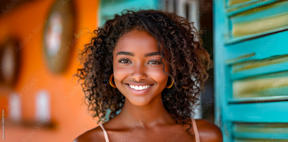 A woman with curly hair is smiling and looking at the camera A woman with curly hair is smiling and looking at the camera