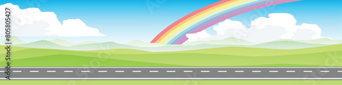Horizontal view of empty asphalt road.  Background of plain grassland and hills with mountain. Under the white clouds and blue sky. rainbow in the middle of the sky