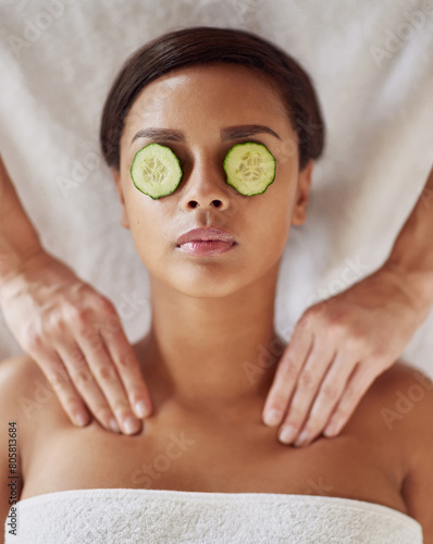 Woman, spa and neck massage for beauty, masseuse hands and cucumber for dark circles. Resting, stress relief and calm for cosmetic and wellness, soothing therapy and natural or luxury treatment