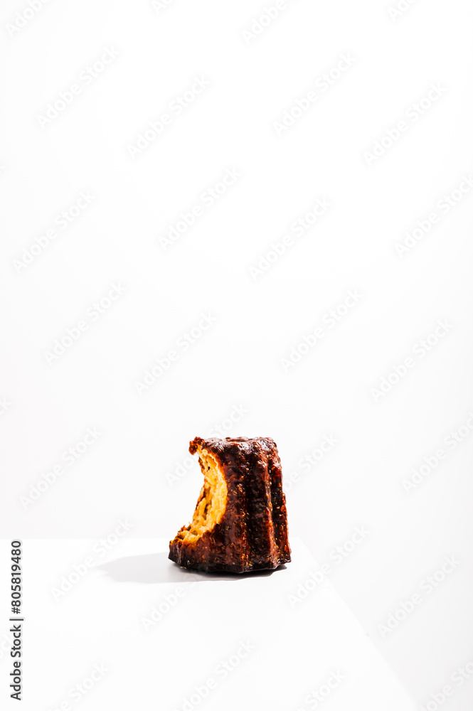 Caneles de bordeaux - traditional French sweet dessert with white table background. Caneles de bordeaux - traditional French sweet dessert with white table background.