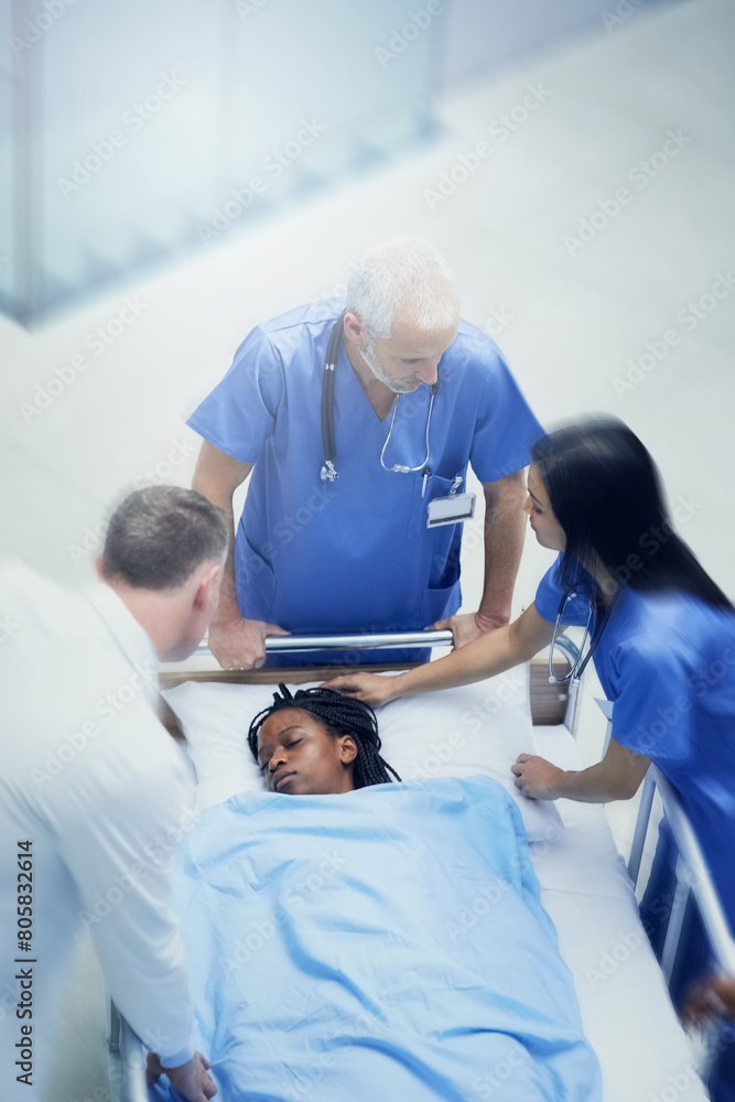 Obraz premium Doctors, woman and patient rush for emergency surgery of accident or injury, trauma and urgency for critical condition. Medical staff or team, run and fast for resuscitation, healthcare and theatre.