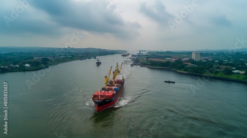 Cargo Ship Navigating Industrial River Channel