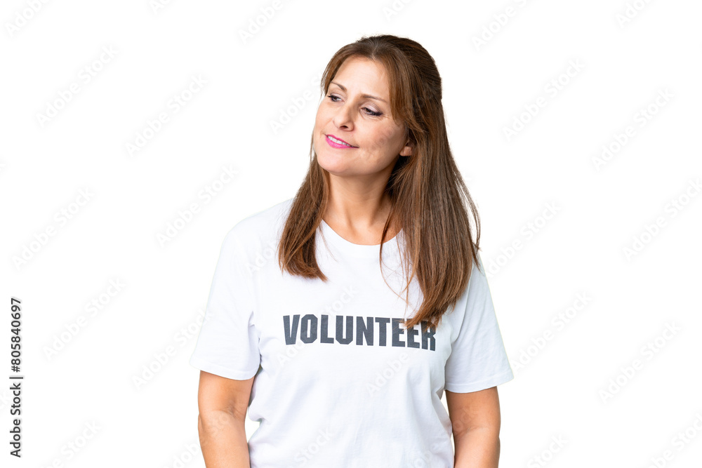 Middle age volunteer woman over isolated background looking to the side and smiling Middle age volunteer woman over isolated background looking to the side and smiling