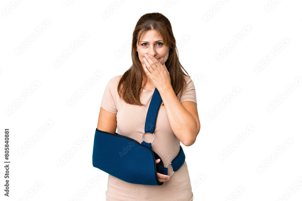 Middle age with broken arm and wearing a sling over isolated background happy and smiling covering mouth with hand Middle age with broken arm and wearing a sling over isolated background happy and smiling covering mouth with hand