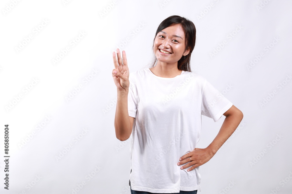 Smiling happy good-looking asian girl giving advice, showing three fingers as explain rules, make point, standing white background Smiling happy good-looking asian girl giving advice, showing three fingers as explain rules, make point, standing white background