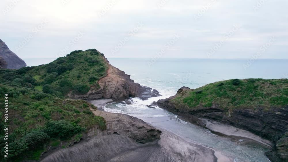 Beautiful Lion Rock on Piha beach in the evening at Auckland, New Zealand Beautiful Lion Rock on Piha beach in the evening at Auckland, New Zealand