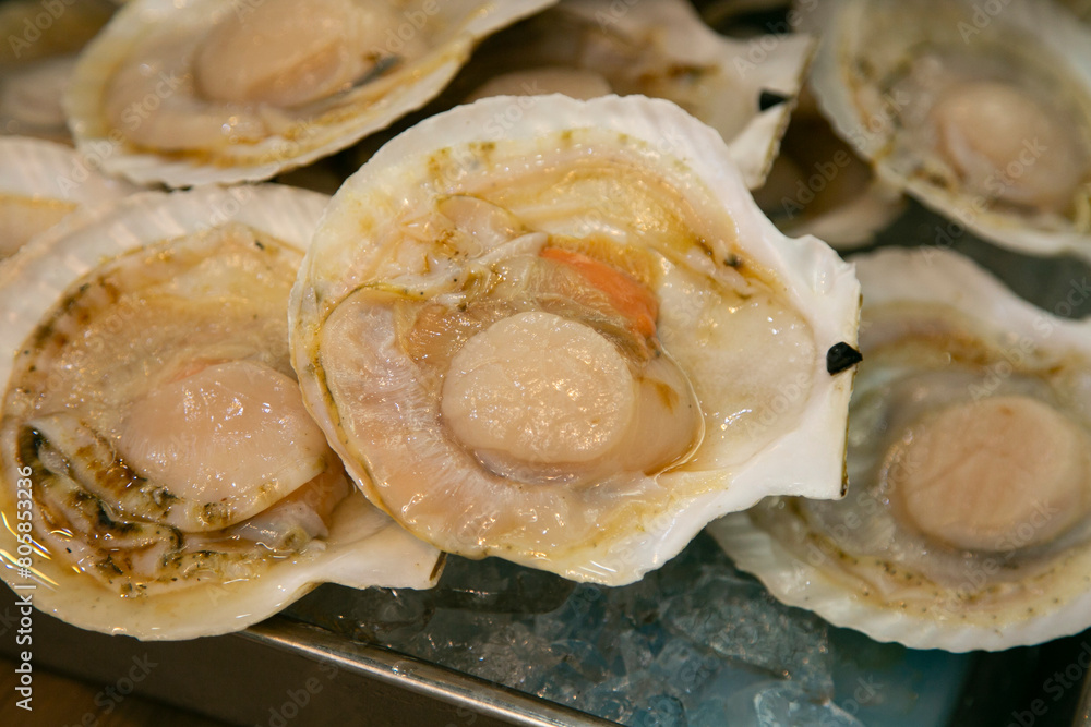 Seafood shell and fish cooked on a grill at the Osaka fish market in Japan. Seafood shell and fish cooked on a grill at the Osaka fish market in Japan.