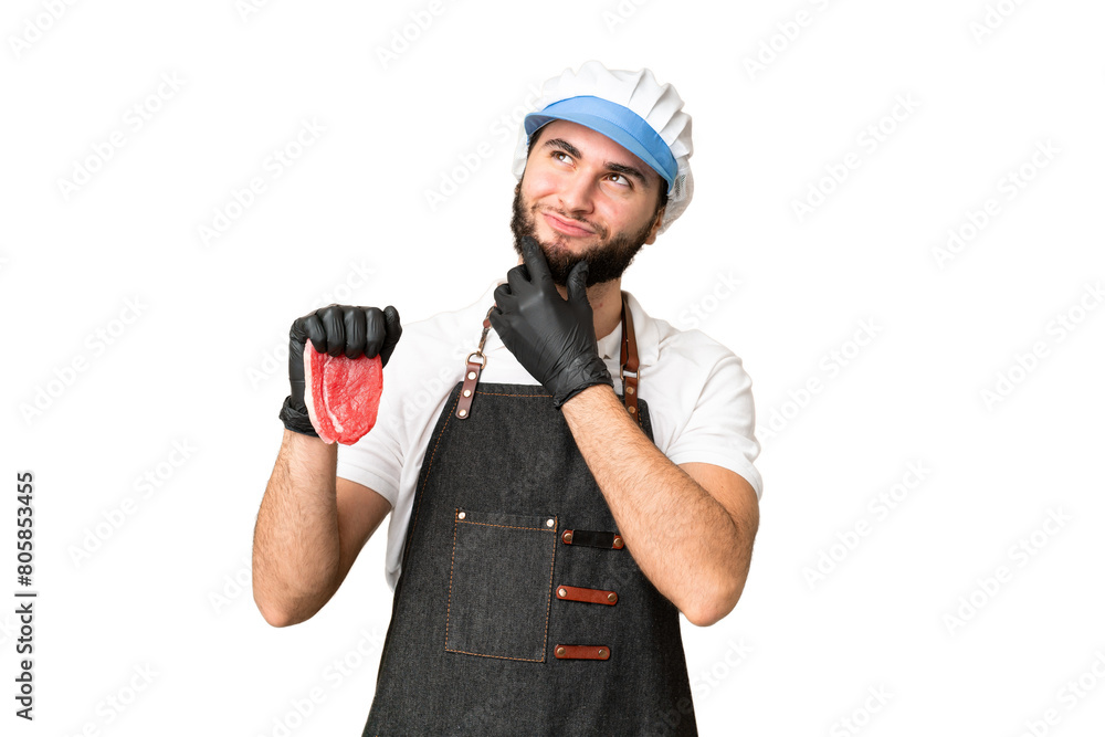 Butcher man wearing an apron and serving fresh cut meat over isolated chroma key background and looking up Butcher man wearing an apron and serving fresh cut meat over isolated chroma key background and looking up