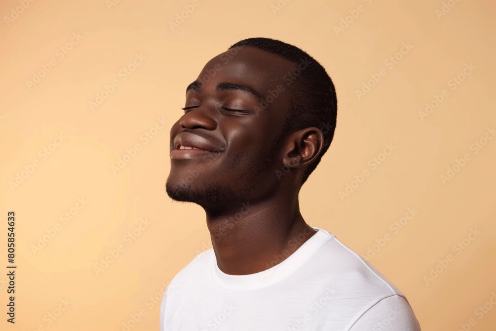 Obraz premium Joyful African American Man Smiling on Beige Background