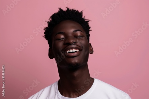 Content African American Man with Eyes Closed on Pink Background
