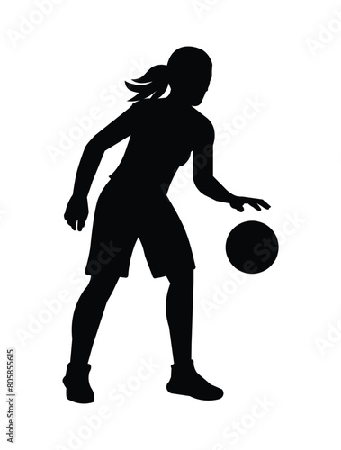 Black silhouette of a girl playing women's basketball and hits the ball dribbling and standing in a half turn photo