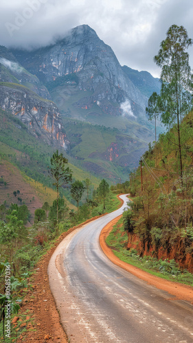 A winding road with a mountain in the background