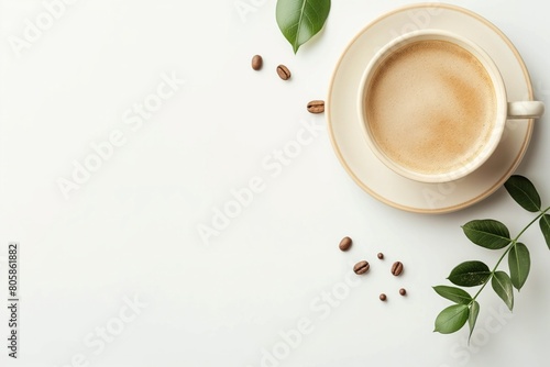 Freshly brewed coffee in a white cup with green leaves on white background