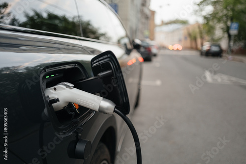 electric car is charging in a residential area. Eco-friendly fuel and modern technologies.