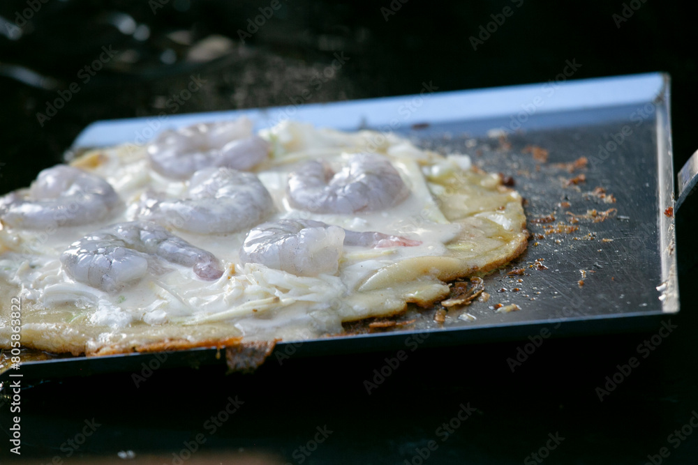Prawn omelet at a food market in Osaka, Japan. Prawn omelet at a food market in Osaka, Japan.