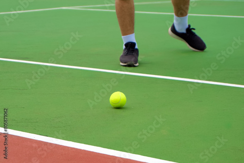 Close up of tennis player legs with black shoe playing on tennis court. Tennis player in the outdoor court © fery