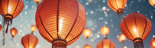 leuchtende asiatische Lampignons in rot orange gelb magisch schwebend vor einem blauen unscharfen Hintergrund mit Bokeh und Glitzern als Banner Vorlage in Nahaufnahme für Feste Party Feiern Hochzeit photo