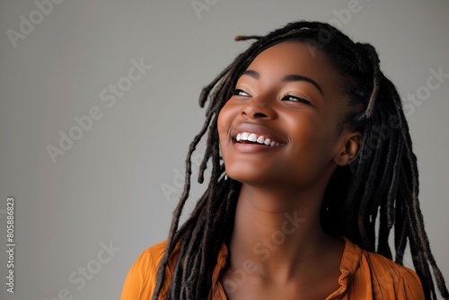 Joyful African American Woman with Dreadlocks Laughing