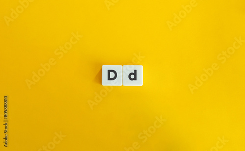 Capital and Small Letter D. Uppercase and Lowercase Letter. Concept of Learning Alphabet. Text on Block Letter Tiles against Yellow Orange Background