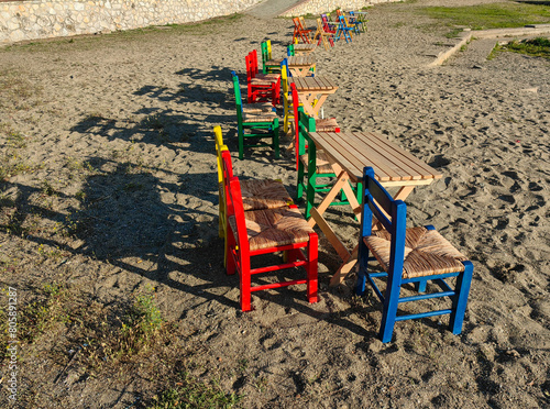 Beachside Palette of Serenity. Colorful Wooden Chairs on the Sand.